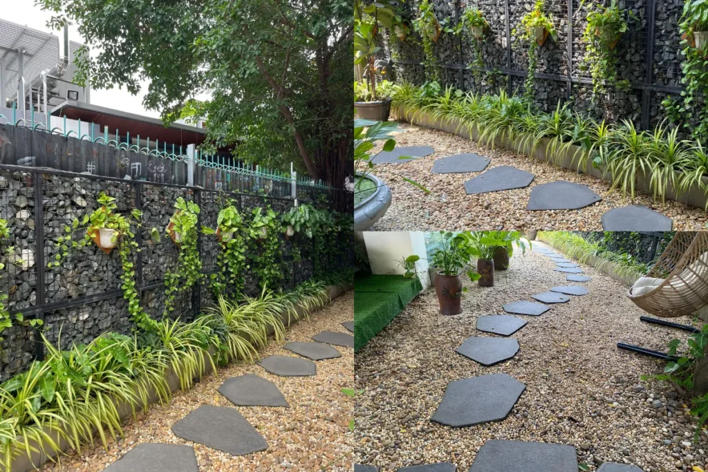 Lối đi sân vườn bằng đá bước dặm trên nền sỏi, hai bên trồng cây xanh thấp sát tường đá.